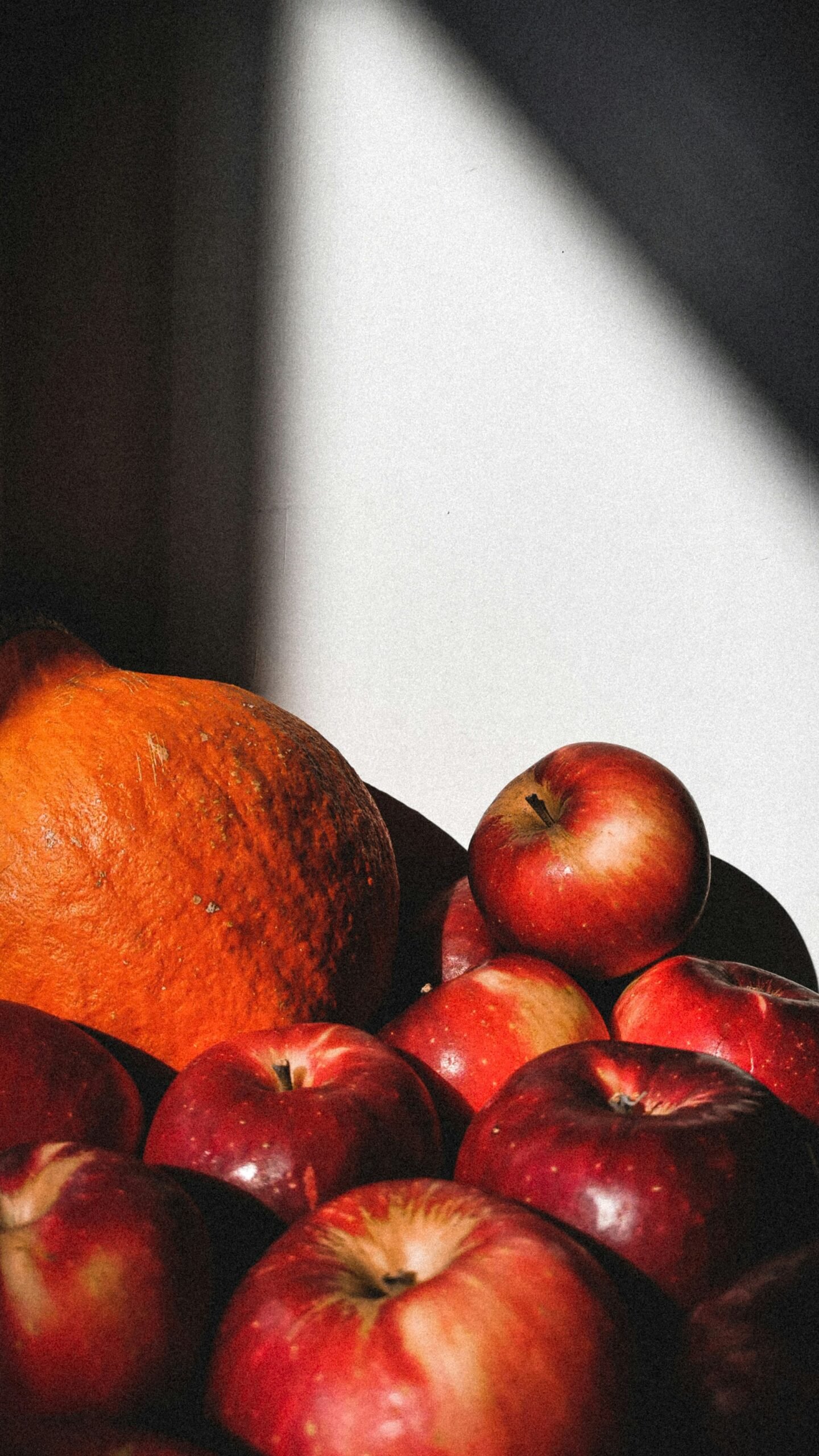 Ingredients for apple pumpkin salad laid out on a wooden surface