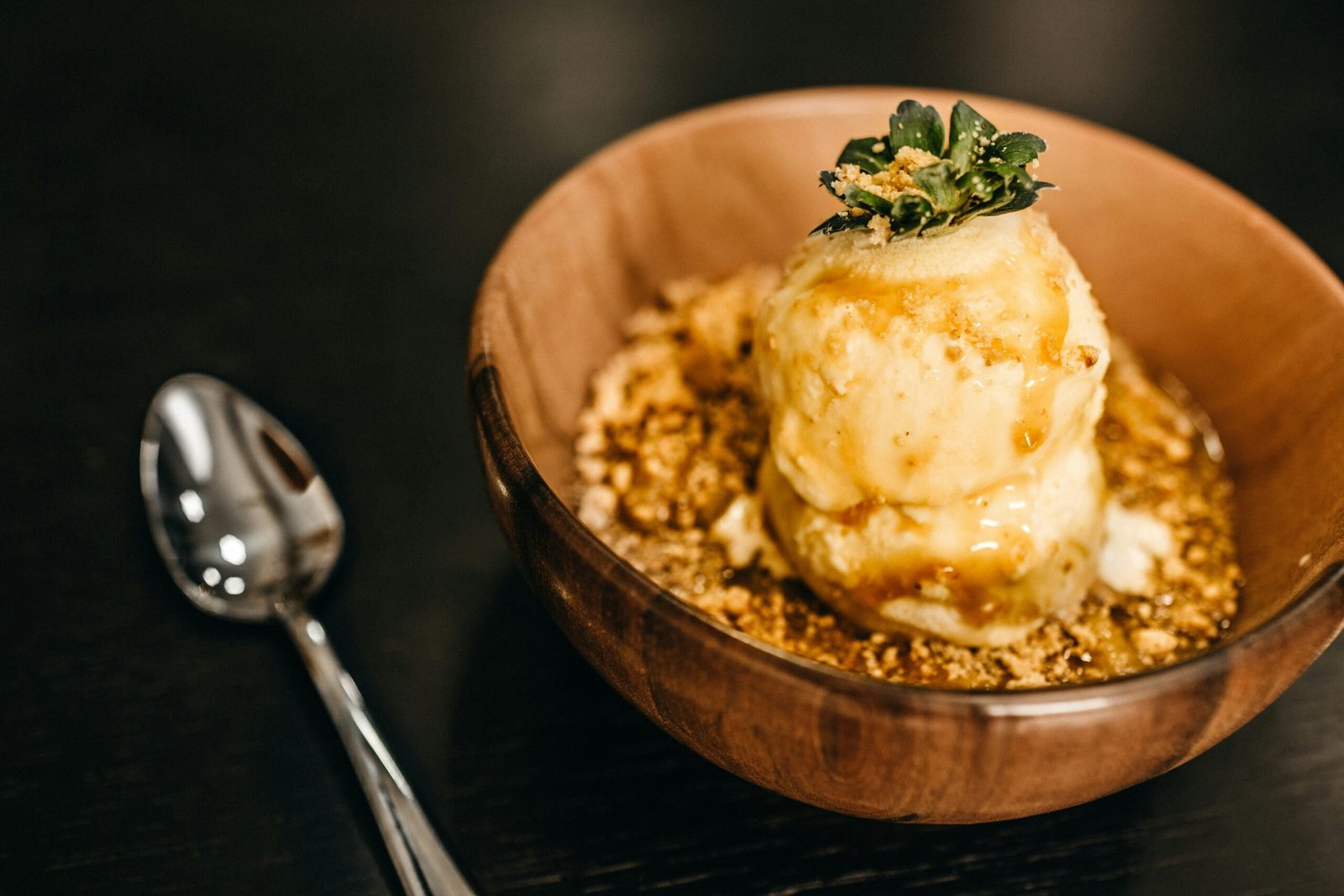 Apple crisp served warm with a scoop of vanilla ice cream